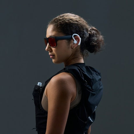 Runner wearing white earshots sports earbuds