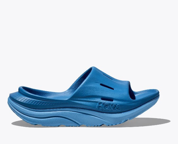 Side view of hoka u ora recovery slide sandal in blue