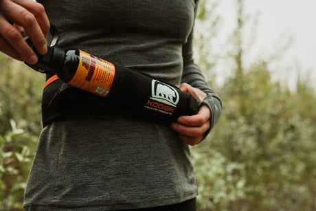 Bearspray being pulled out of kodiak bear spray belt