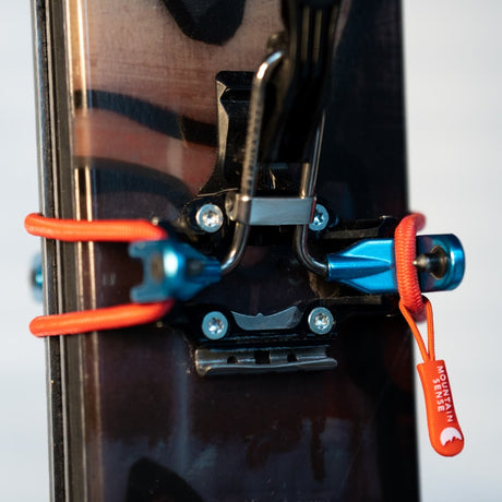 Mountain Sense C Ski Tie wrapped around pin binding on skis