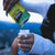 Pouring lime naak energy drink mix into a soft flask