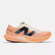 Side view of men's New Balance FuelCell Rebel v4 running shoe in mango/angora/black colour