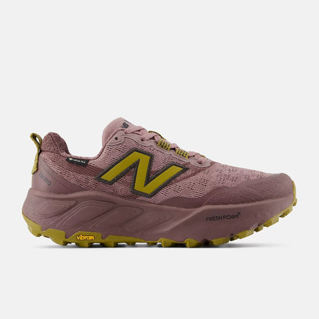 Side view of women's pink/gold New Balance Hierro v9 Gore-Tex trail running shoe