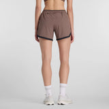 Back on-model view of women's brown New Balance RC Essential shorts