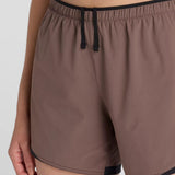 Waist tie detail of women's brown New Balance RC Essential shorts