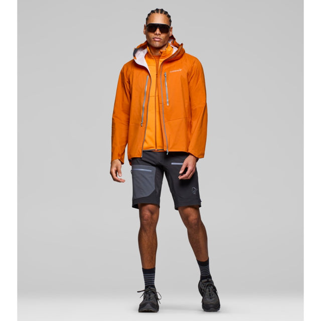 Model wearing men's norrona falketind dri1 orange waterproof jacket