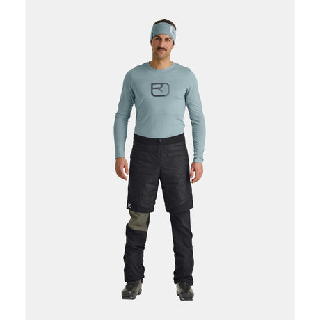 On-model view of men's black Ortovox Piz Boe insulated shorts
