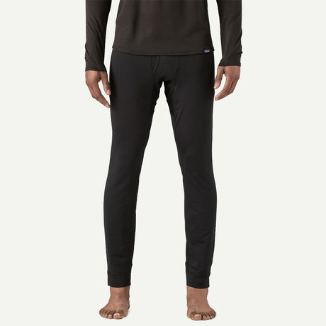 Front on-model view of men's Patagonia Capilene thermal bottoms in black