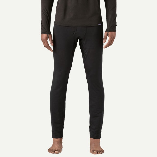 Front on-model view of men's Patagonia Capilene thermal bottoms in black
