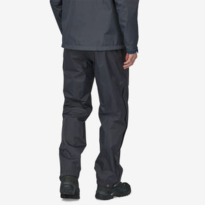 Back of model wearing men's patagonia torrentshell rain pants in black