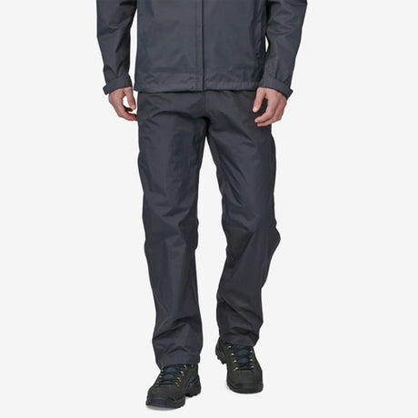 Front of model wearing patagonia torrentshell rain pants in black