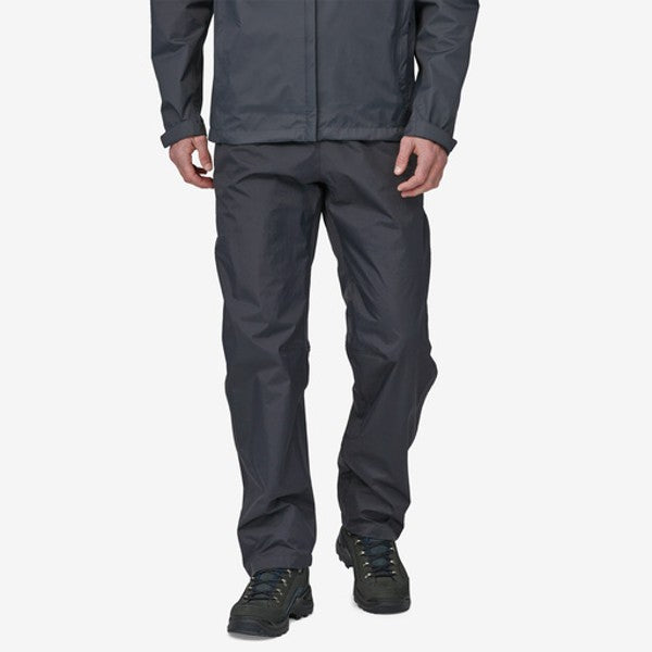 Front of model wearing patagonia torrentshell rain pants in black