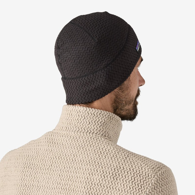 Back on-model view of black Patagonia R1 Air Beanie