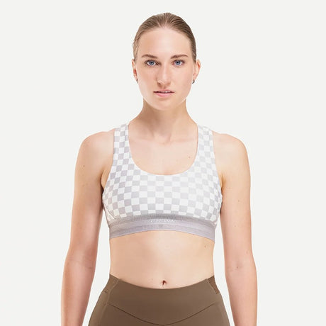 Front on-model view of women's checkered grey/white Peppermint Cycling sports bra