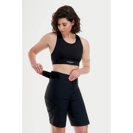 Side on-model view of women's black Peppermint Cycling mountain bike shorts