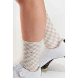 Person wearing a checkered socks with cycling shoes