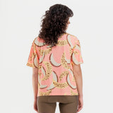 Back on-model view of women's banana/grapefruit print Peppermint Cycling shirt