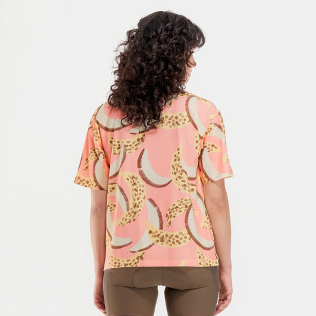 Back on-model view of women's banana/grapefruit print Peppermint Cycling shirt