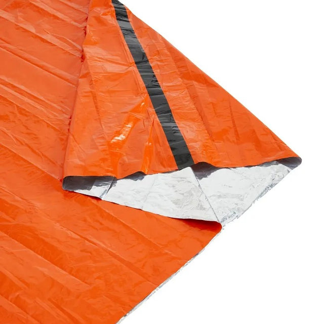 An orange reflective emergency blanket with a silver foil backing, folded to show its texture and reflective properties on the inside