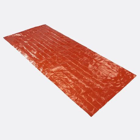 A rectangular orange-red emergency blanket shown diagonally on a light gray background.