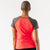 Back view of women's rabbit EZ Tee Perf SS Trail in fiery coral