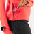 Pocket detail of women's rabbit UPF Deflector 2.0 pullover in fiery coral