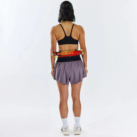 Person wearing Raide running belt with poles attached