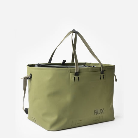 Angle view of green RUX waterproof 50L tote bag straps up