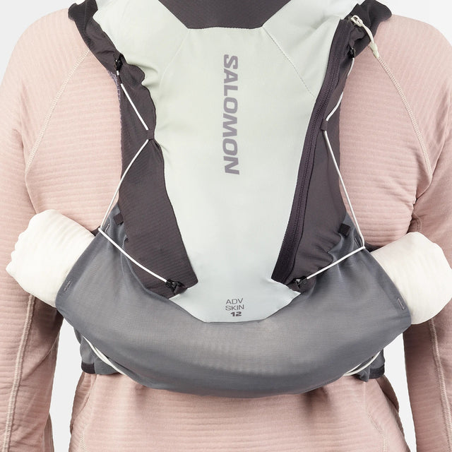 Back on-model view of green/grey Salomon ADV Skin 12 running vest