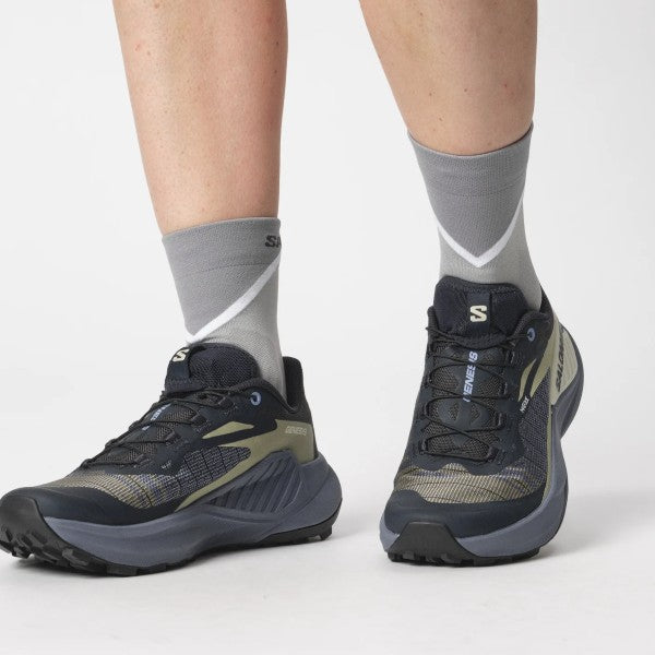 On-model view of salomon genesis women's trail running shoes in carbon/grisaille/aloe wash colour