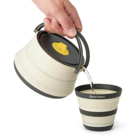 Pouring water from the Sea to Summit ultralight collapsible kettle into the collapsible cup