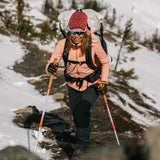Person hiking on a mountain with a backpack and trekking poles