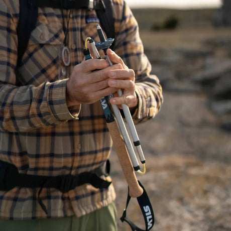 Person folding up a Silva collapsible trekking pole