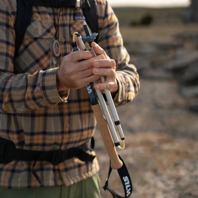Person folding up a Silva collapsible trekking pole