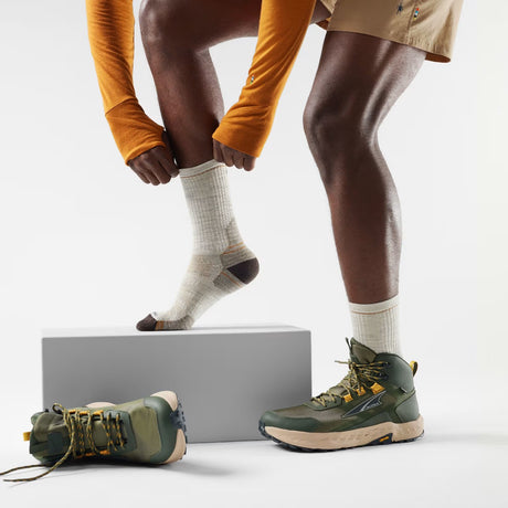 Hiker putting on white/brown Smartwool Hike mid crew socks