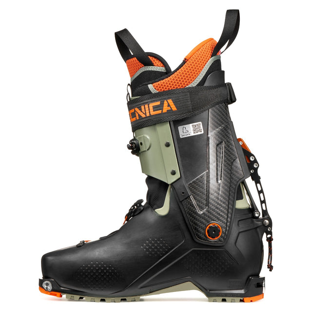 Inner side view of a green/orange Tecnica Zero G Peak Carbon backcountry ski boot