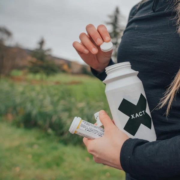Adding an xact nutrition electrolyte tabs to a water bottle