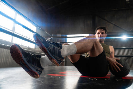 Man exercising on a mat in a gym setting