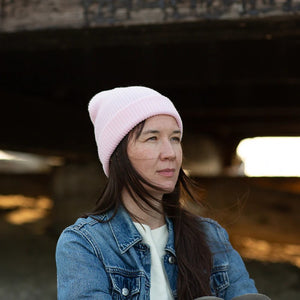 Model wearing a pink XS Classic Beanie